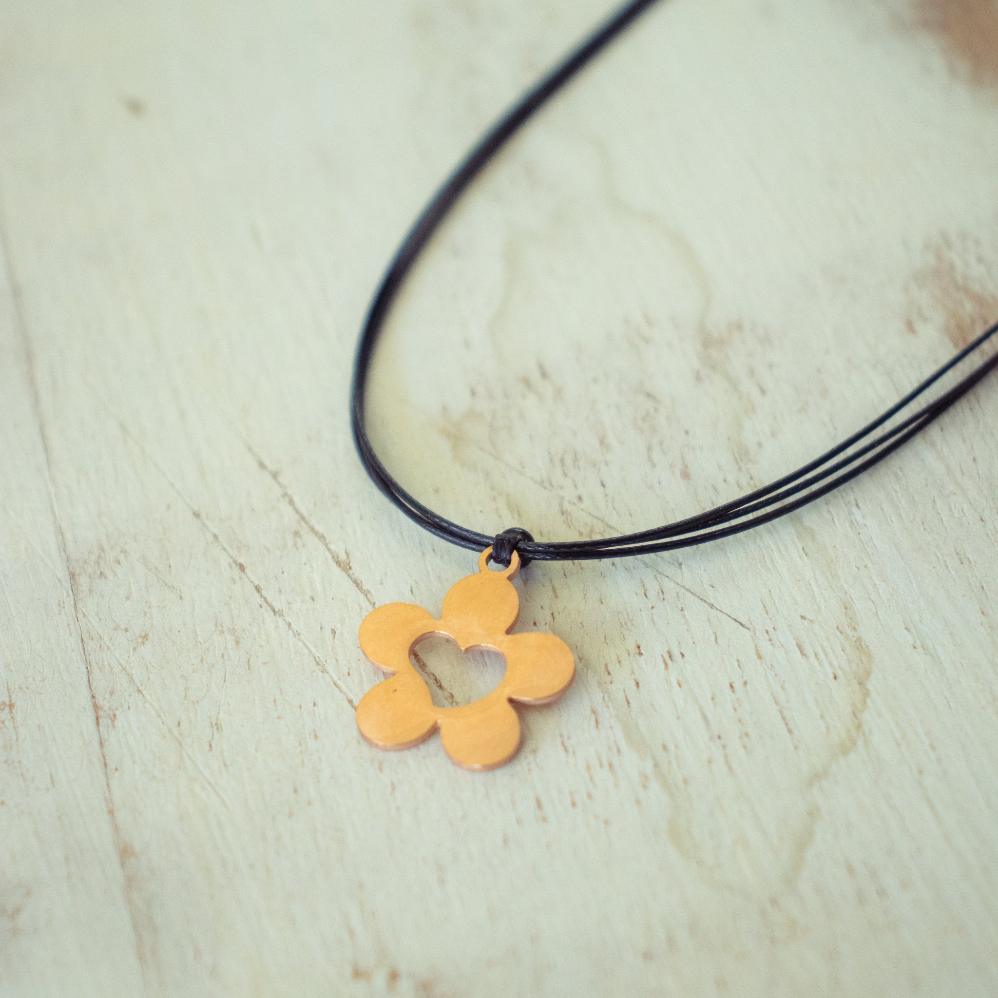 Rose Gold Flower Charm with Cut Out Heart on Black Cord