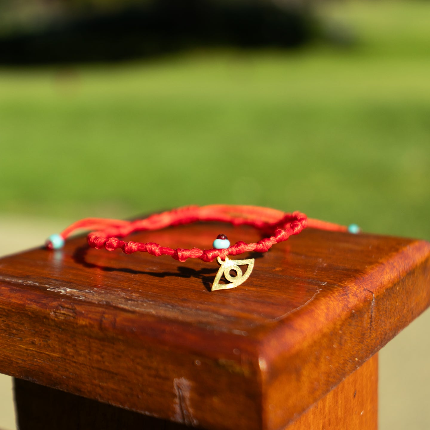 Gold Evil Eye on Red Intermittent Cord